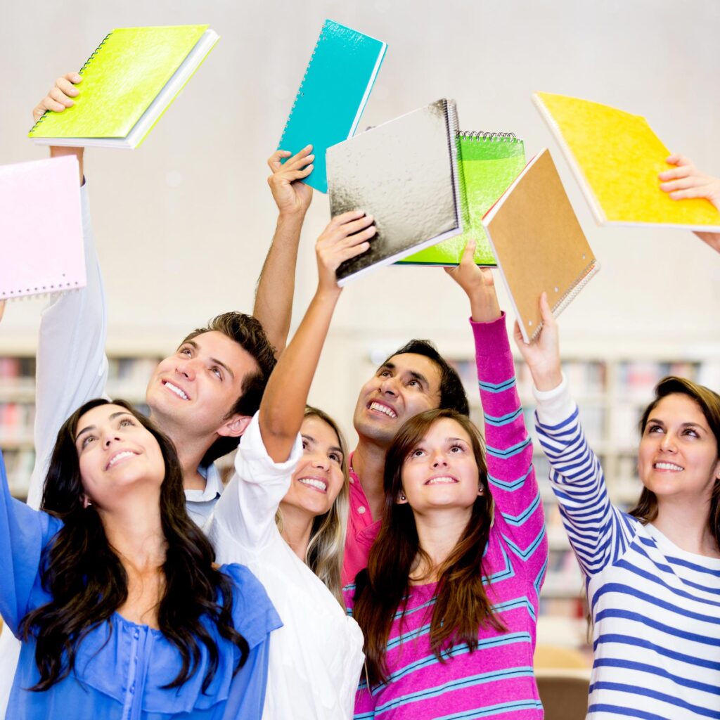 smiling pupils holding up exercise books
